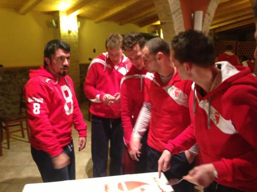a group of men standing around a table cutting a cake at Relais Il Mulino in Corigliano Calabro