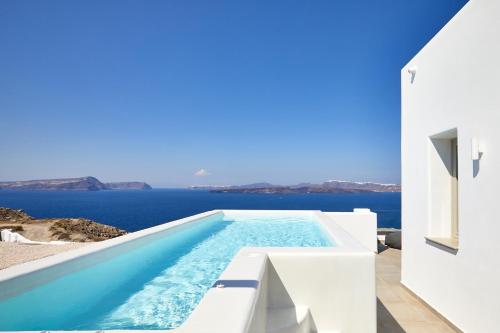 a swimming pool with a view of the ocean at Phos The Boutique in Akrotiri