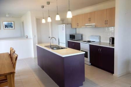 a kitchen with a sink and a stove top oven at Bayview Beach House Apartment No 1 in Kingscote