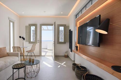 a living room with a flat screen tv on a wall at Phos The Boutique in Akrotiri