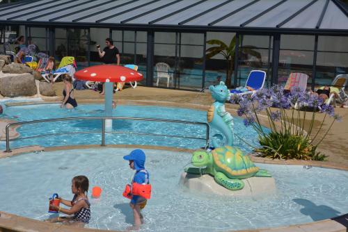 a group of children playing in a swimming pool at Lebraz 3 Appartement in Saint-Lunaire