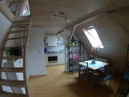 a kitchen and dining room with a staircase and a table at Ferienwohnung Regina in Albstadt