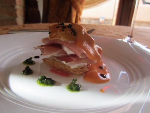 a plate of food with bacon and broccoli on it at Relais Il Mulino in Corigliano Calabro