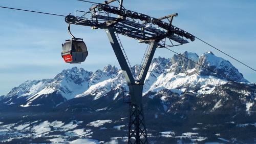 a ski lift in front of a snow covered mountain at Chalet Terry in Sankt Johann in Tirol