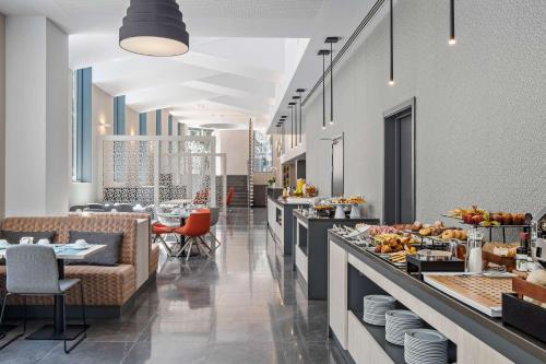a restaurant with a buffet line with tables and chairs at EXE Liberdade in Lisbon
