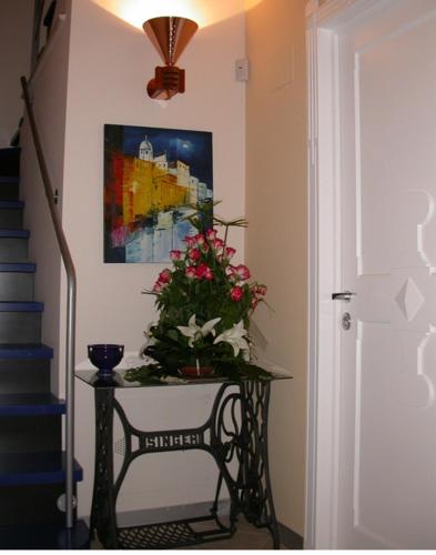 a hallway with a table with flowers on it at Bed & Breakfast Palazzo Ducale in Andria