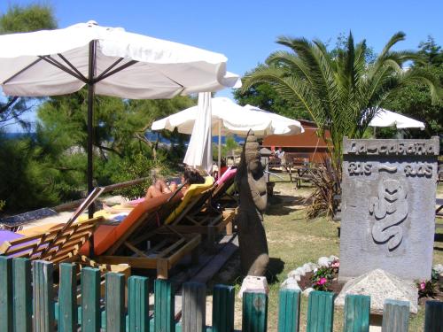 a couple of people laying in chairs under an umbrella at Hotel Pineda Playa in Noja