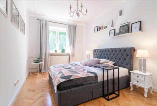 a bedroom with a bed and a chandelier at Old Town Heart V - Mariensztat in Warsaw