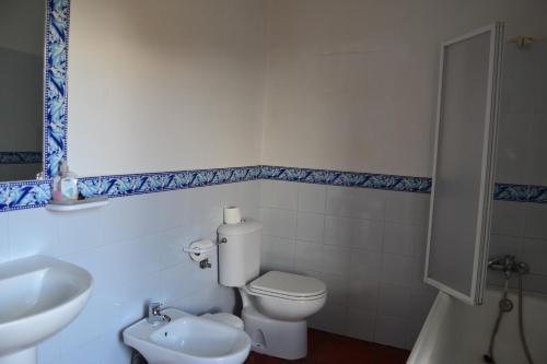 a bathroom with a white toilet and a sink at Amanecer en Campos in Población de Campos