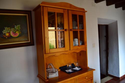 a wooden cabinet with glass doors in a room at Amanecer en Campos in Población de Campos