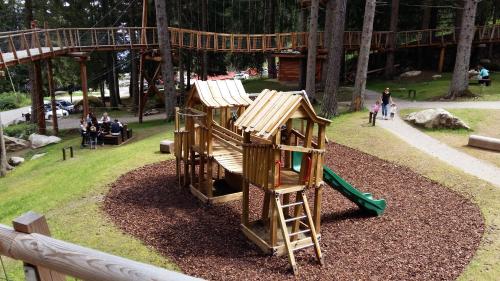 a park with a playground with a slide at Nido nelle Dolomiti Apartment in Marilleva