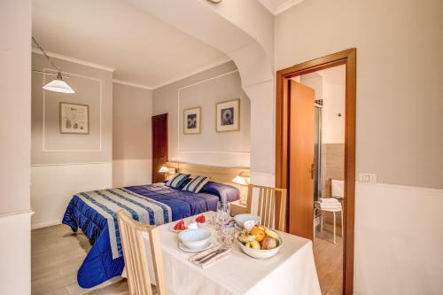 a room with a bed and a table with a bowl of fruit at Hotel Residence Magnolia in Rome