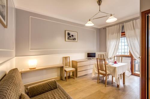 a living room with a table and a couch at Hotel Residence Magnolia in Rome