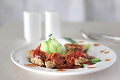 a plate of food with vegetables on a table at Three Eight Front One Boutique Batu Malang in Batu