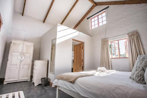 a bedroom with a large bed and a window at Bella Manga Country Escape in Plettenberg Bay