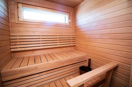 a small wooden sauna with a window in it at Pro Apartments 1 in Vaasa