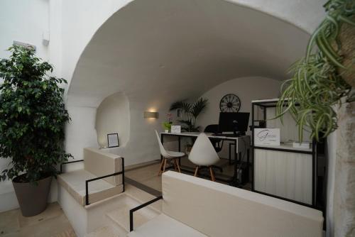 un bureau avec des plantes et un bureau dans une chambre dans l'établissement GH Dimora Sant'Anna-Lofts & Apartments, à Carovigno