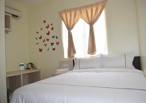 Postel nebo postele na pokoji v ubytování Angsoka Hotel
