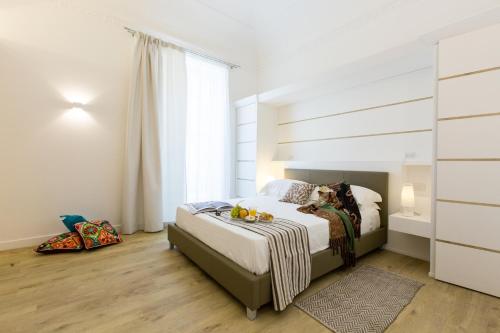 Ένα ή περισσότερα κρεβάτια σε δωμάτιο στο Palermo In Suite Aparthotel