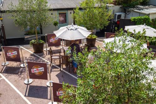 a person sitting at a table under an umbrella at The Globe in Exeter