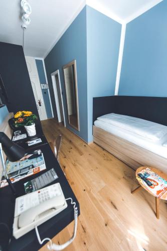 a room with a bed and a desk with a phone at Altstadthotel Kasererbräu in Salzburg