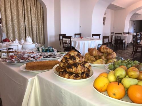a table with many plates of food on it at Palazzo Cestari Hotel in Montesano sulla Marcellana