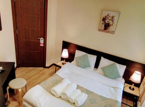 a bedroom with a bed with towels on it at Old Town Mtatsminda in Tbilisi City