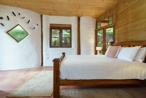 a bedroom with a large bed in a room at Cobhearthome in Maleny