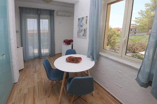 a room with a table and chairs and a window at villa aurora in Giardini Naxos
