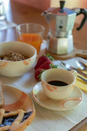 a table with two cups of coffee and plates of food at Badia Agriturismo in La Torraccia
