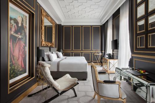 a bedroom with a bed and a table and chairs at Sofia Boutique Residence in Yogyakarta