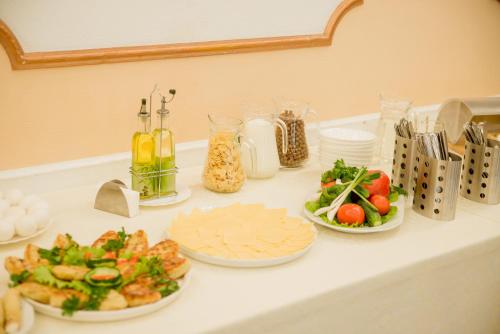 a buffet with plates of food on a table at Dniprovski Zori in Kremenchuk