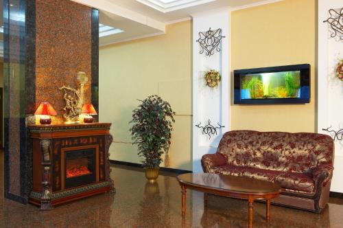 a living room with a couch and a fireplace at Dniprovski Zori in Kremenchuk