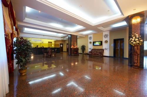 a lobby with a couch and a chair in a building at Dniprovski Zori in Kremenchuk