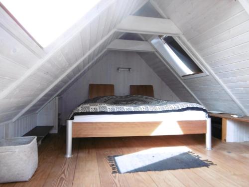 a bedroom with a bed in the attic at 4 Louisenlund in Skanderborg