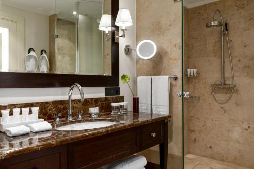 a bathroom with a sink and a shower at Grand Hotel Kempinski High Tatras in Štrbské Pleso