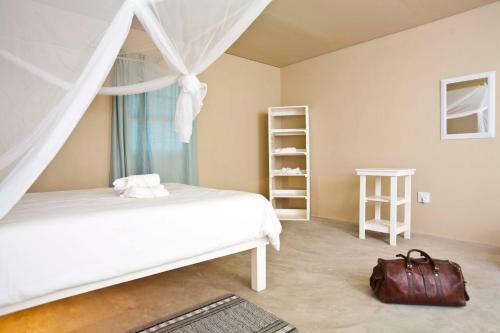 Tempat tidur dalam kamar di Sesfontein Guesthouse