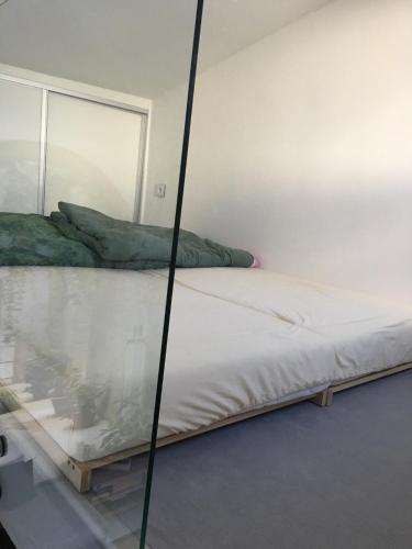 a bed in a room with a glass wall at Tiny House with Private Pool in Jánošíková