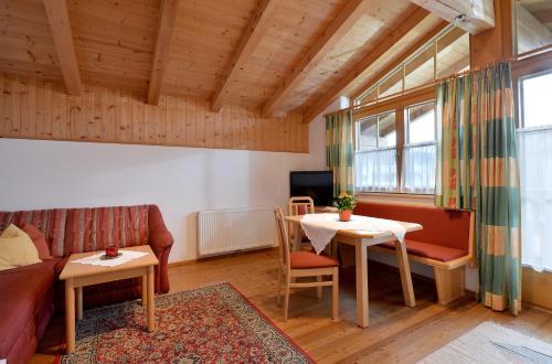 a living room with a couch and a table at Appartments Antoniushof in Ellmau