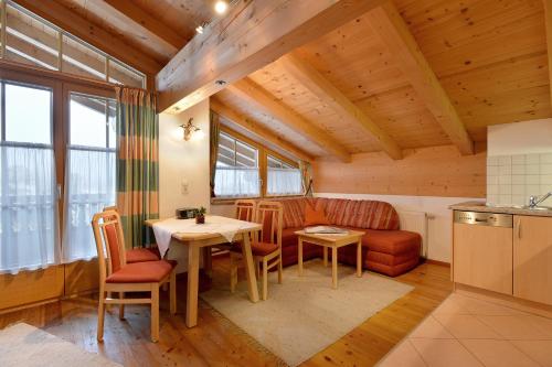 a kitchen and dining room with a table and chairs at Appartments Antoniushof in Ellmau