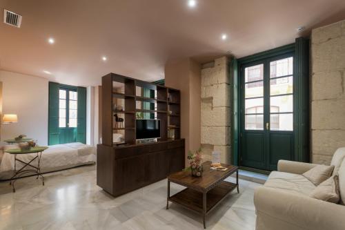 a living room with a couch and a tv at Luces de Catedral in Alicante