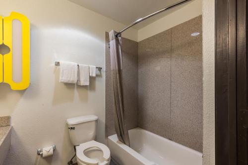 a small bathroom with a toilet and a shower at Studio 6-Port Arthur, TX - SE in Port Arthur
