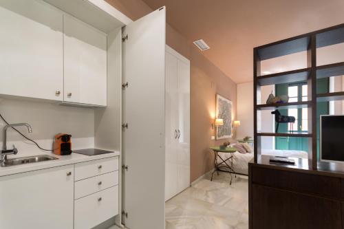 a kitchen with white cabinets and a sink at Luces de Catedral in Alicante