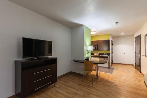 a living room with a flat screen tv and a dining room at Studio 6-Port Arthur, TX - SE in Port Arthur