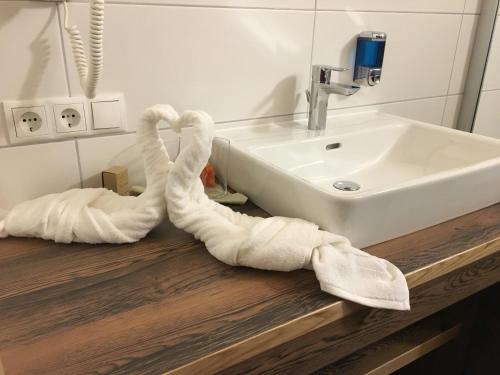 a bathroom with towels on a counter next to a sink at Gasthof Martha in Nauders