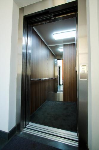 a hallway of an office building with a elevator at Aparthotel BC 29 Residence in Kraków