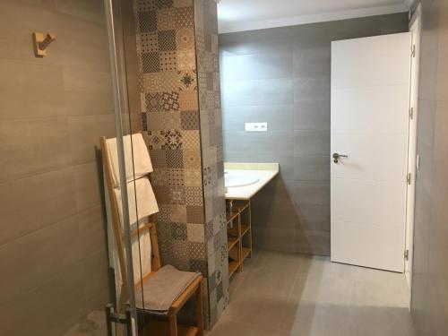 a small bathroom with a sink and a shower at Apartamento San José by CasaTuristica in Ronda