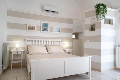 ポリニャーノ・ア・マーレにあるMestmiché by Polignandoのベッドルーム1室(白い大型ベッド1台付)