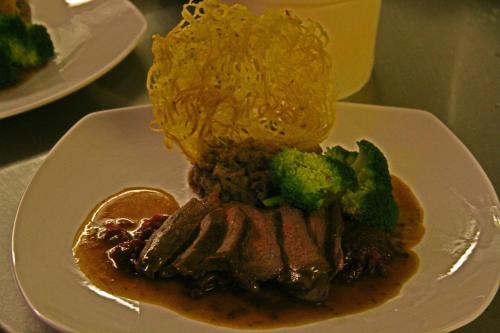 a plate of food with meat and broccoli on a table at Annandale Arms Hotel in Moffat