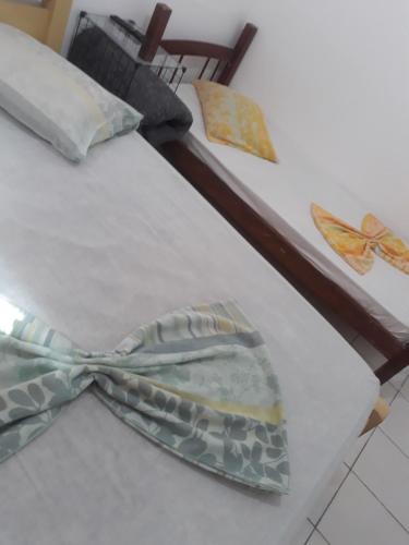 a bow tie sitting on top of a bed at Hotel Ideal Taubaté in Taubaté